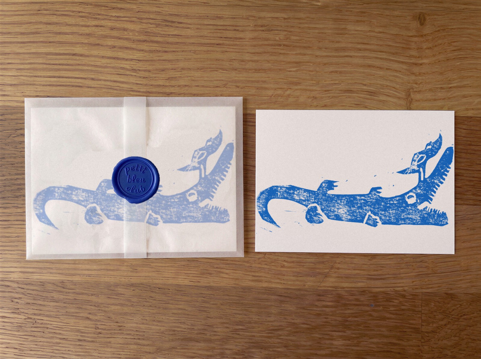 Petit Bleu Club October 2026: hand-pulled blue crocodile and bird print and a glassine envelope sealed with a Petit Bleu Club wax seal
